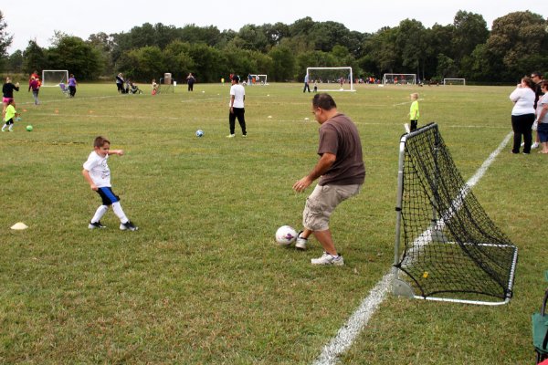 Nick plays soccer with Dad